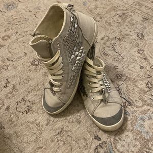 Gray sneaker high tops with studs.
